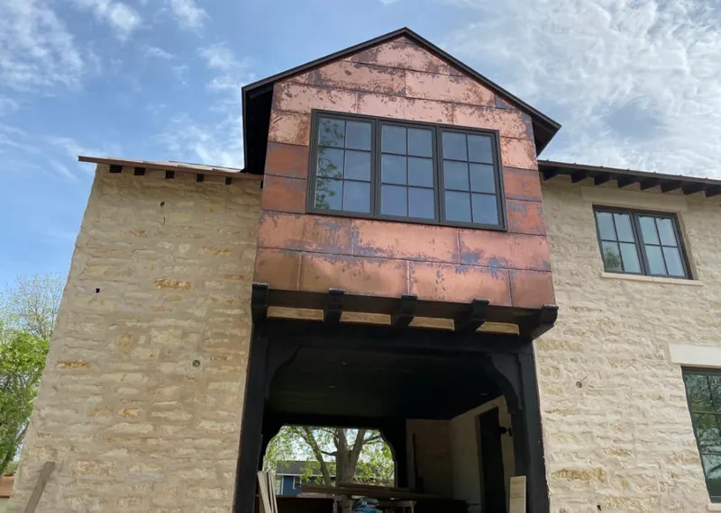 Copper metal panel facade on a stone building for Roof Repair in Highland Heights
