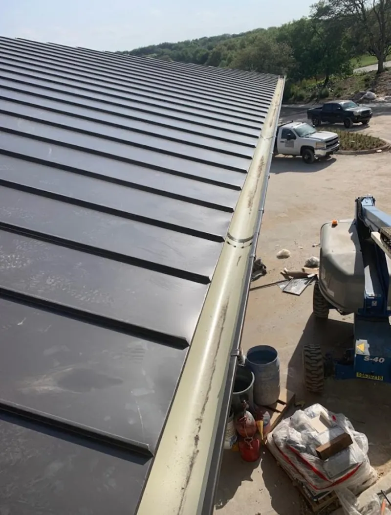 Standing seam panel and gutter detail on a metal roofing jobsite in Highland Heights